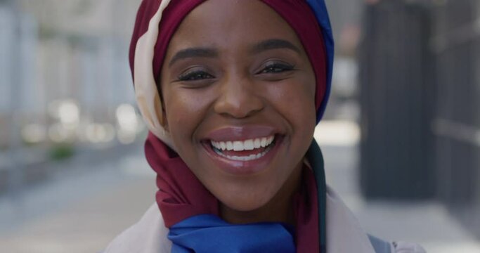 Portrait happy african american business woman smiling in city urban scene