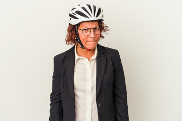 Middle age latin business woman wearing a bike helmet isolated on white background confused, feels doubtful and unsure.