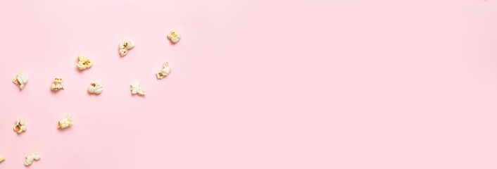 Fototapeta na wymiar Salted popcorn on a pink background. Top view with copy space. Flat lay