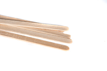Pack of wooden sticks isolated on a white background. Stirrers for tea, coffee, ice cream. Decoration.