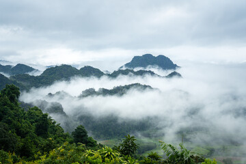 A beautiful view of mountain range with greenery forest and misty environment in the morning time. Relaxation with nature view, scenic photo seen.