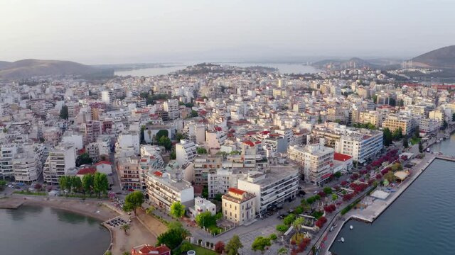 4k drone forward video (Ultra High Definition) of Chalcis town, Greece. Stunning evening seascape of Aegean sea, North Euboean Gulf. Impressive summer scene of Euboea island, Greece, Europe.