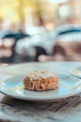 A piece of homemade napoleon cake with cream on a table in a street restaurant. Tasty morning food