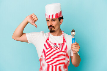 Young caucasian maker holding a scoop isolated on blue background feels proud and self confident, example to follow.