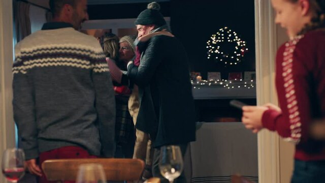 christmas family hugging arriving for dinner party celebrating festive holiday reunion with friends enjoying season greeting at home 4k footage