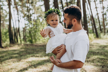 Young father holding his one year baby daughter