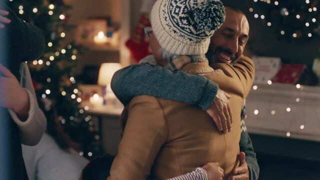 grandparents visiting for christmas eve hugging family enjoying festive holiday celebration on winter evening at home 4k footage