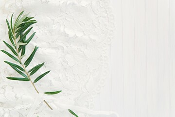 White minimal wedding flat lay composition with greenery, bride dress laces, empty space for text or design, bridal background mockup.