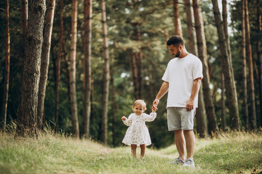 father walking in park with his baby daughter