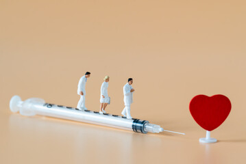 Miniature people Doctor and Nurse emergency medical team walking on syringe with copy space using for digital health retreat take care for covid-19 Coronavirus Immunization vaccinated Hospitality Ads
