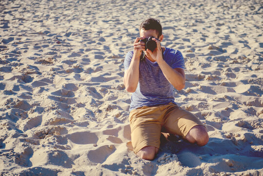 Silhouette of young photographer on the beach