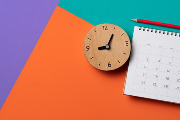 close up of calendar and clock on the colorful table background, planning for business meeting or...