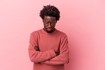 Fototapeta na wymiar Young african american man isolated on pink background unhappy looking in camera with sarcastic expression.