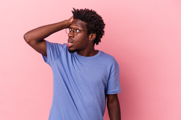 Young african american man isolated on pink background being shocked, she has remembered important meeting.