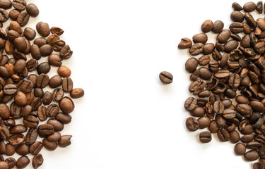 top view of brown roasted coffee beans stripes along the either side on white background