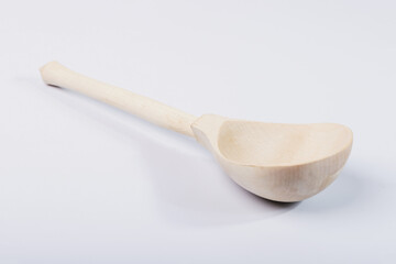 Wooden spoon on white isolated background.