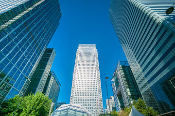 Fototapeta premium Office buildings, skyscrapers, road, bus in the business district of London Canary Wharf, UK.