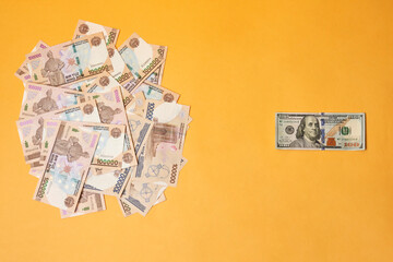 US dollar banknote and Uzbek sums. Concept of exchange rate, Uzbek sum to us dollar. Money exchange in Uzbekistan. Pile of Uzbek money sum and American dollar bill