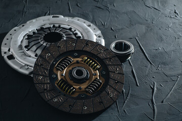 Automotive clutch mechanism, disc, basket and bearing for auto on a black background.