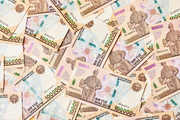 Pile of Uzbek sum currency money bill. A stack of one hundred thousand Uzbek sum. Uzbek money. 100000 sum