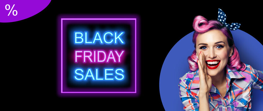 Beautiful excited woman holding hand near open mouth. Girl dressed in pin up. Purple red haired happy smiling model at retro fashion vintage concept. Black Friday sales neon light sign.