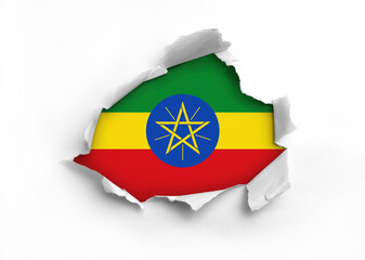 Flag of Ethiopia underneath the ripped paper