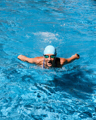 Fototapeta na wymiar Young woman training at the swimming pool