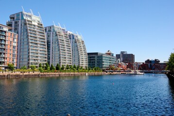 Curved residential buildings overlooking Huron Basin from the waterside of North Wharf in Greater Manchester, England, UK
