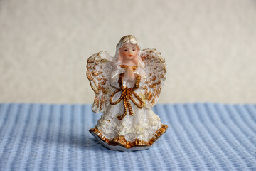 A little toy angel with wings prays