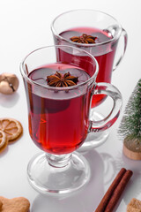 Hot red mulled wine isolated on white background with christmas spices