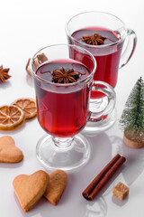 Hot red mulled wine isolated on white background with christmas spices