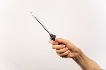 Mano sosteniendo herramienta, destornillador, fondo blanco.