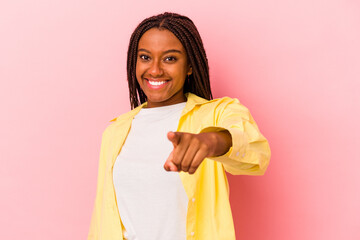 Young african american woman isolated on pink background  cheerful smiles pointing to front.