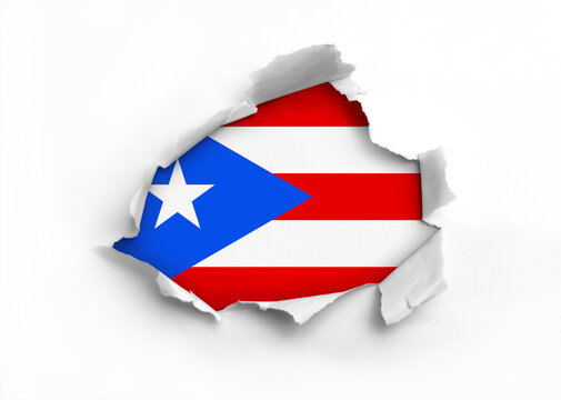 Flag of Puerto Rico underneath the ripped paper