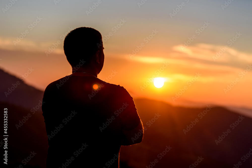 Canvas Prints Man with hands on chin stand on the mountain and watching over the misty sunset