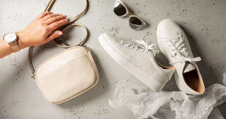 Fashion and accessories - white sneakers shoes, small handbag and sunglasses