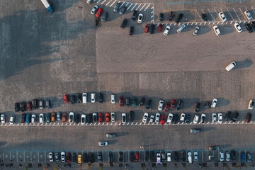 Fototapeta premium Different cars are packed in city square. Large area and spontaneous parking. Aerial drone shot.