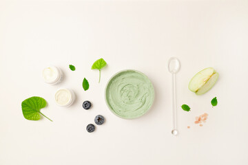 Cosmetic glass bottle, jar with nature eco cream and moisturizer tube with herbal ingredients on white surface