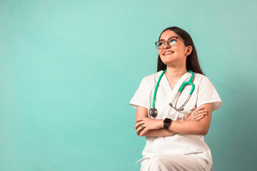 Young happy latin american woman with glasses and a stethoscope wear folded arms medicine uniform.