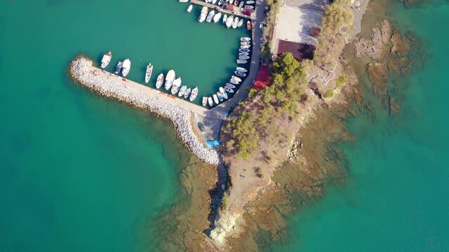 4k drone flight up footage (Ultra High Definition). Sunny morning cityscape of Chalcis town, Greece. Colorful summer seascape of Aegean sea, North Euboean Gulf. Euboea island, Greece, Europe..