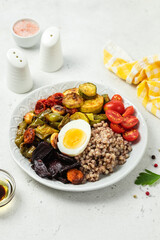 Egg buckwheat roasted veggie bowl. Space for text.