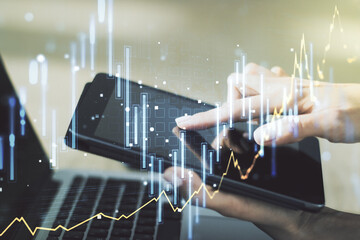 Multi exposure of abstract creative financial graph with finger presses on a digital tablet on background, forex and investment concept