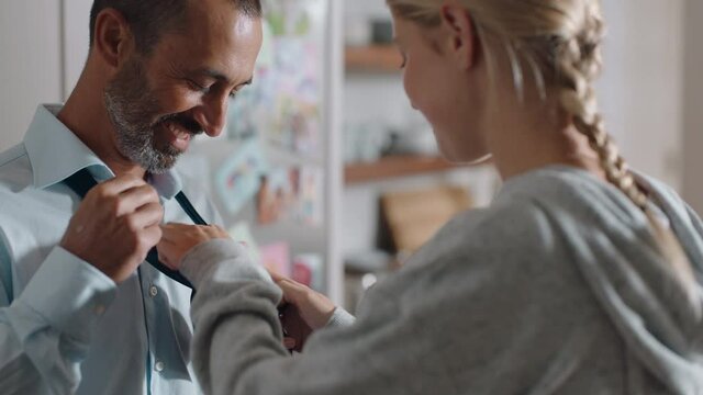 teenage girl helping father with tie getting ready preparing for work dad high fives daughter for success happy family at home 4k footage