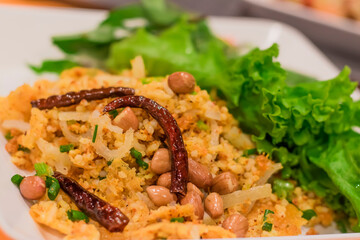 Thai style fried rice salad in a dish topped with fried vegetables and chilli