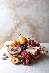 Appetizers table with italian antipasti snacks or authentic traditional spanish tapas set. Fall fruit, cheese and meat variety board.