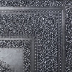  Decorative asian chasing art framework with arabesque pattern in form of embossing on metal.Textured metal frame backdrop with ancient oriental floral wavy ornament. Carved silver black background.