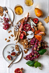 Appetizers table with italian antipasti snacks or authentic traditional spanish tapas set. Fall fruit, cheese and meat variety board. Top view, flat lay