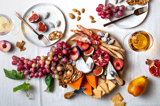 Appetizers table with italian antipasti snacks or authentic traditional spanish tapas set. Fall fruit, cheese and meat variety board. Top view, flat lay