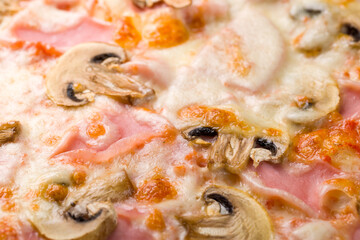 Pizza with ham and mushrooms and cheese close up macro
