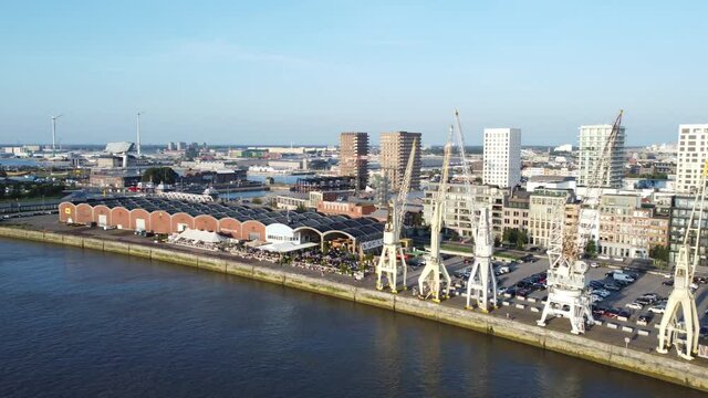 Aerial drone video of the historical harbor cranes on the docks in Antwerp covering from the Waagnatie to Hangar 27 and the MAS museum